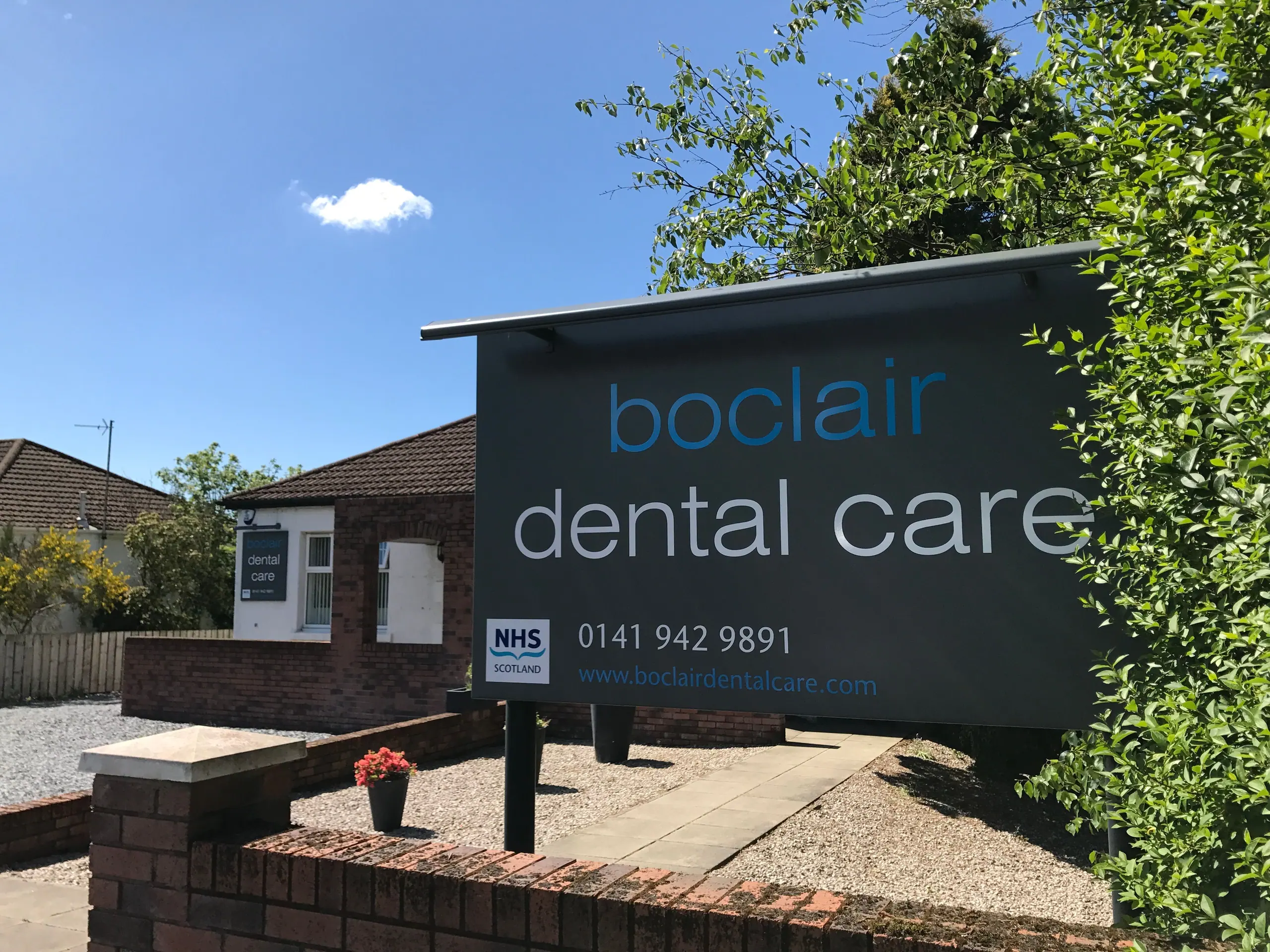 Boclair Dental Care's sign and building on Milngavie Road on a sunny day